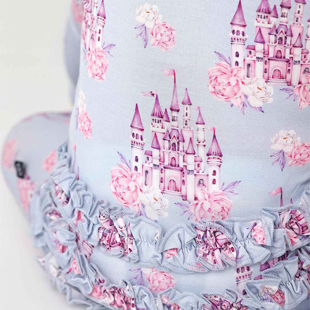 Baby headband with pink castle and floral design on a light blue background