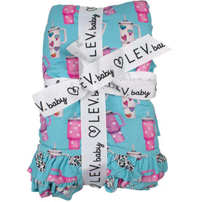 Baby blanket with cup pattern and 'LEV baby' ribbon on a white background