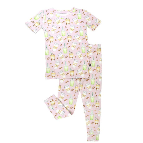 Children's pajama set with coffee pattern on a pink background