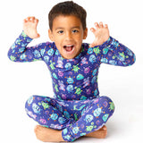 Child wearing a colorful monster-themed outfit on a white background