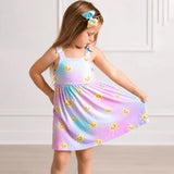a girl wearing a dress with a pastel tie-dye gradient in pink, blue, and purple, featuring a yellow smiley sun print and a knotted shoulder strap, shown on a white background.
