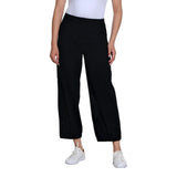 A model wearing black wide-leg cropped pants with white sneakers and a white top, shown from the waist down on a solid white background.