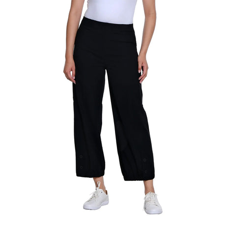 A model wearing black wide-leg cropped pants with white sneakers and a white top, shown from the waist down on a solid white background.