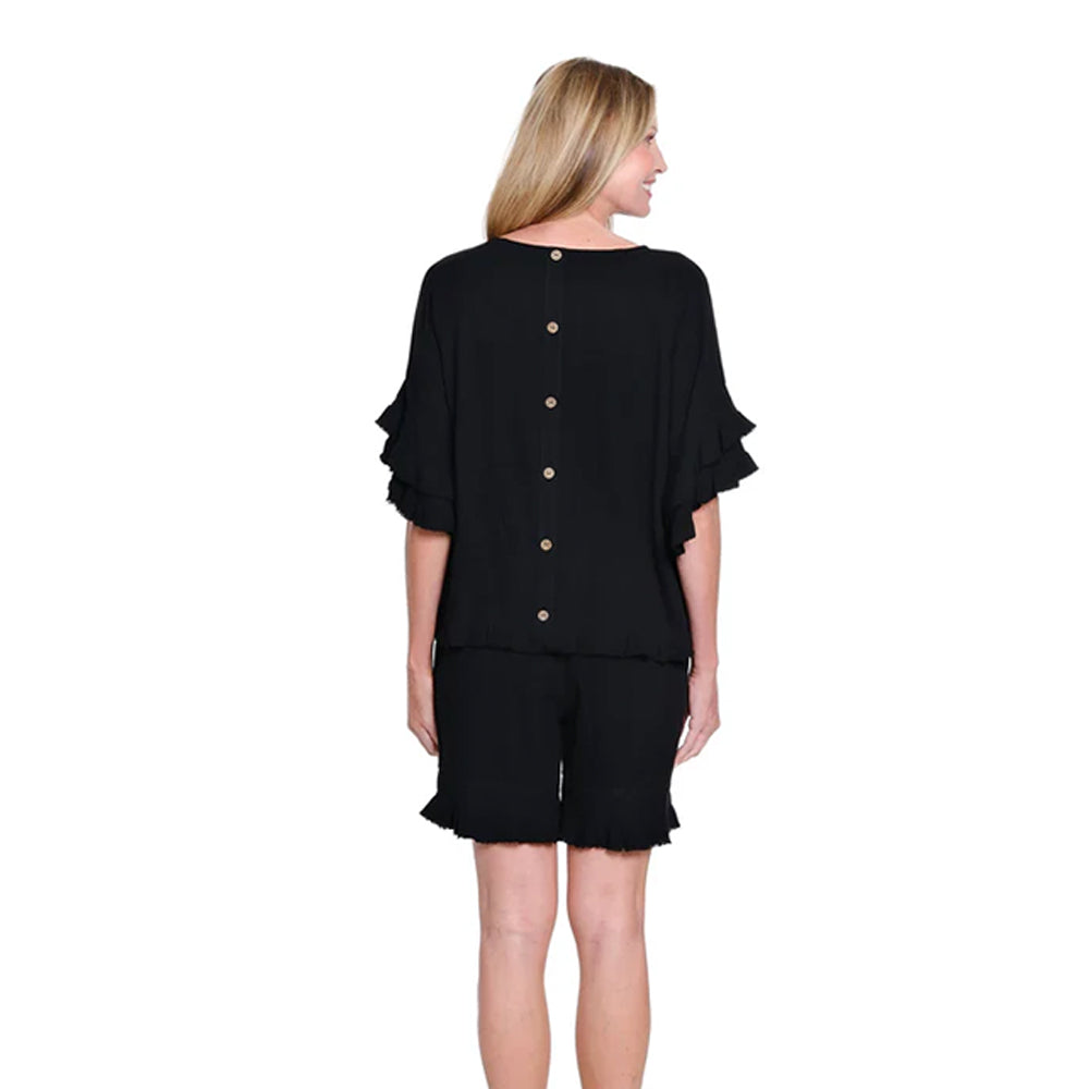 Woman wearing a black outfit with ruffled sleeves on a white background