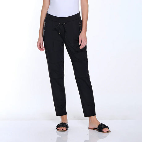Person wearing black pants with zippers on a white background