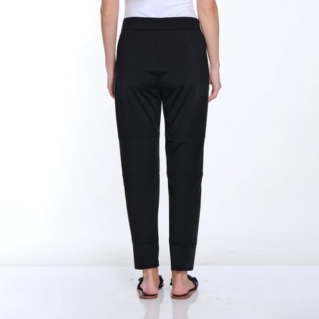 Black pants worn by a person on a white background