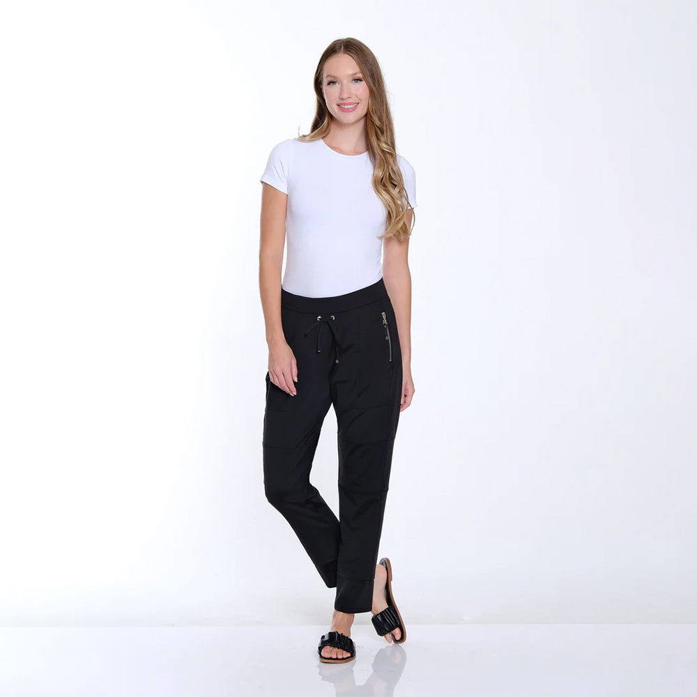 Woman wearing a white t-shirt and black pants on a white background