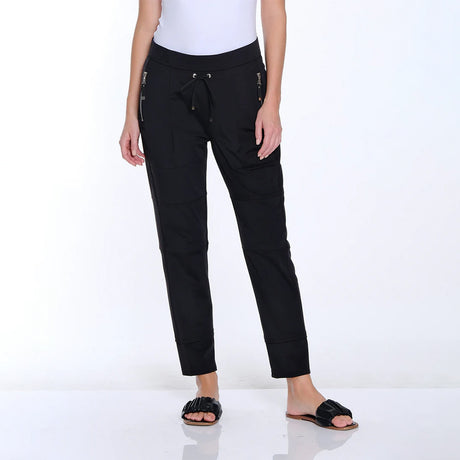 Person wearing black pants with zippers on a white background