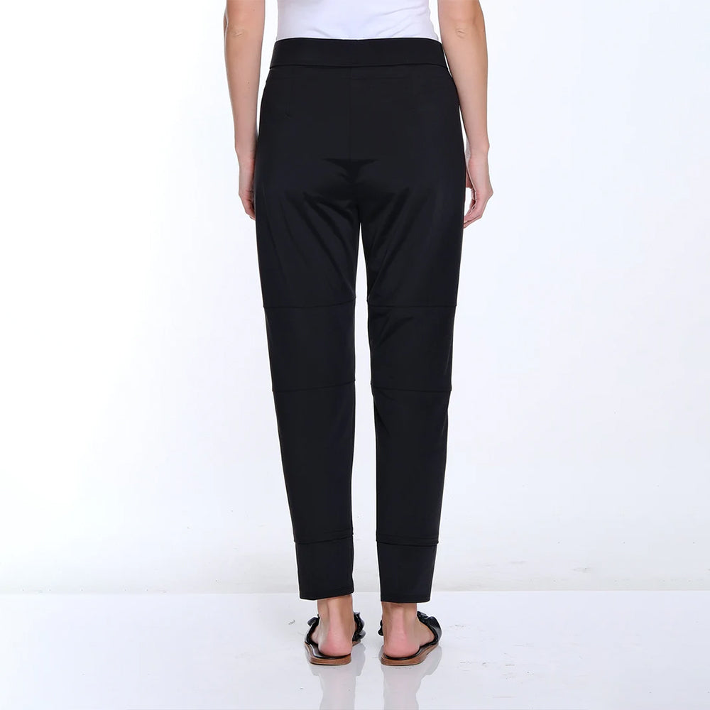 Black pants worn by a person on a white background
