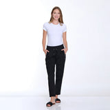 Woman wearing a white t-shirt and black pants on a white background