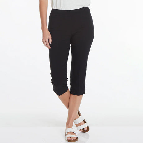 Person wearing black capri pants on a white background
