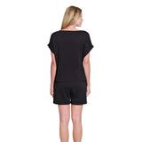 Woman wearing a black outfit on a white background