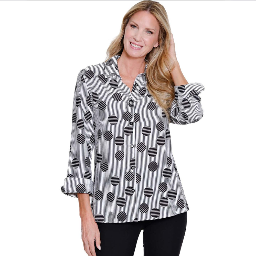 Woman wearing a black and white patterned blouse on a white background