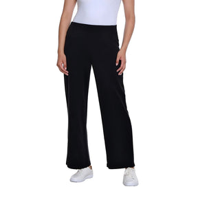 A model wearing black wide-leg cropped pants with a white top and white sneakers, shown from the waist down against a plain white background.