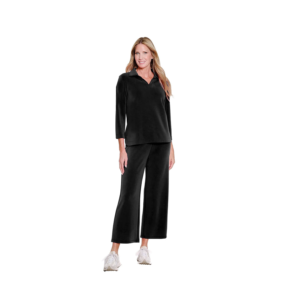 Woman wearing a black outfit on a white background