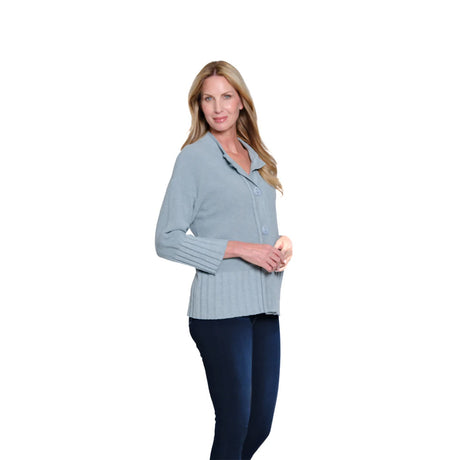 Woman wearing a light blue sweater and dark blue pants on a white background