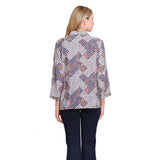 A woman viewed from the back wearing a long-sleeve collared blouse with a navy, white, and orange chevron pattern, paired with dark navy pants, against a plain white background.