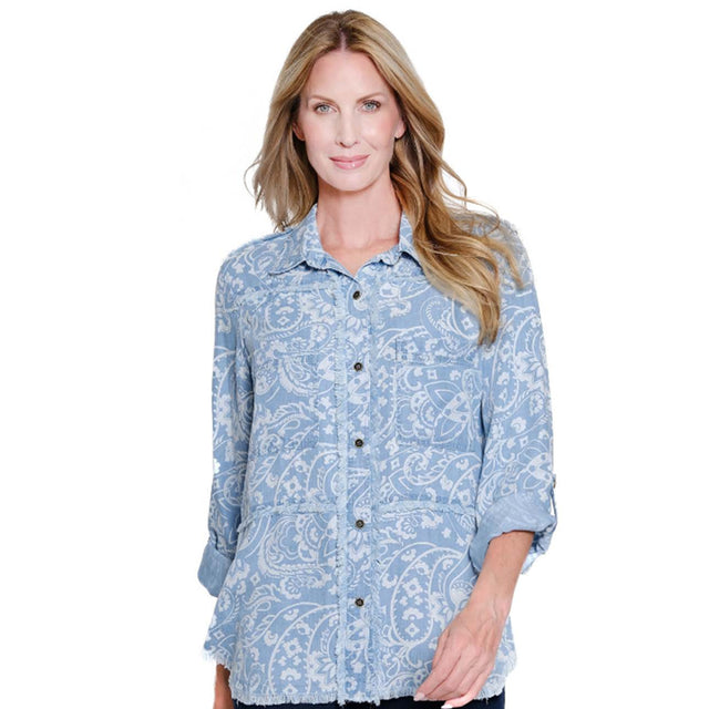 Woman wearing a blue paisley patterned shirt on a white background