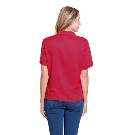 Woman wearing a red shirt and blue jeans on a white background