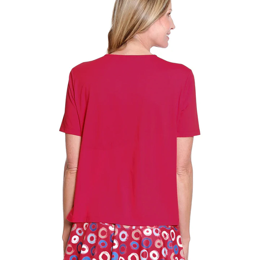 Woman wearing a red top with a colorful skirt on a white background