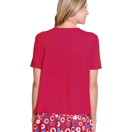 Woman wearing a red top with a colorful skirt on a white background