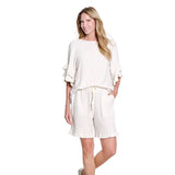 Woman wearing a white outfit on a white background