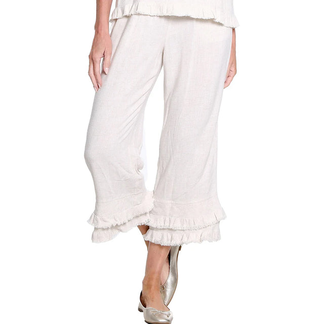 White ruffled pants worn by a person on a white background