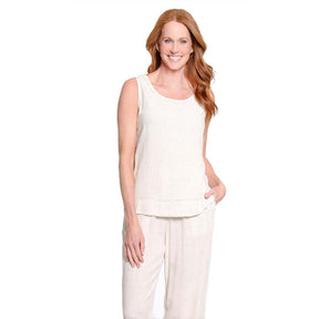 A woman modeling a matching two-piece loungewear set consisting of a sleeveless cream tank top and matching cream pants, set against a plain white background.