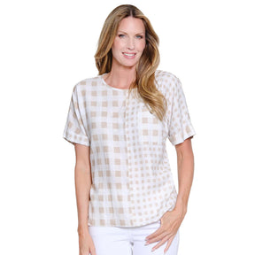 Woman wearing a white and beige checkered blouse on a white background
