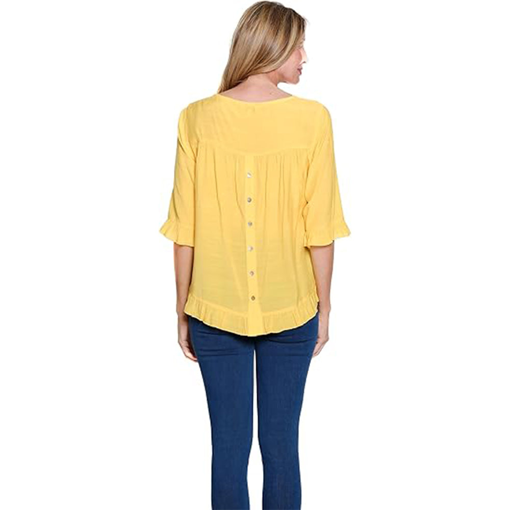 Woman wearing a yellow blouse and blue jeans on a white background
