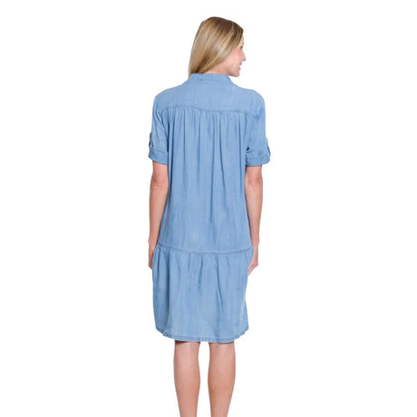 Woman wearing a light blue dress on a white background