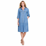 A woman viewed from the front wearing a light blue tiered shirt dress with three-quarter sleeves, shown against a plain white background.