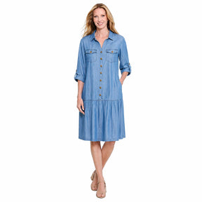 A woman viewed from the front wearing a light blue tiered shirt dress with three-quarter sleeves, shown against a plain white background.