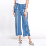 Person wearing blue jeans with white stripes on a white background