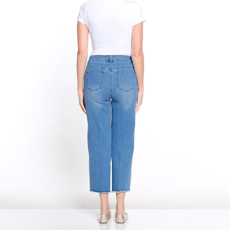 Person wearing blue jeans on a white background
