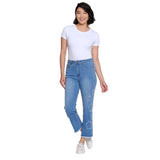 Woman wearing blue jeans with floral designs on a white background