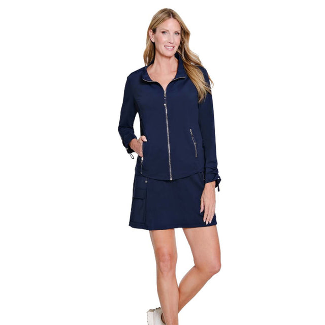 Woman wearing a navy blue outfit with a jacket and skirt on a white background