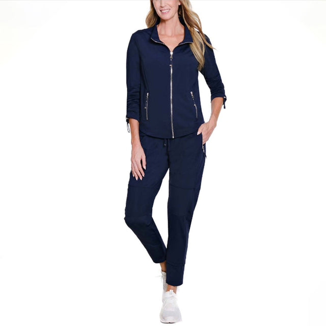 Woman wearing a navy blue tracksuit on a white background