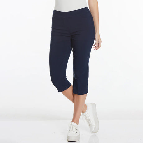 Navy blue capri pants worn by a person on a white background