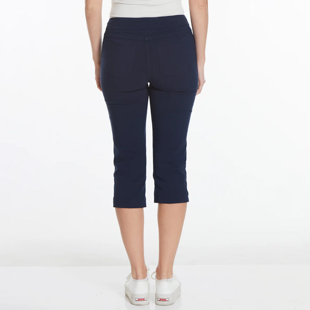 Navy blue capri pants worn by a person on a white background