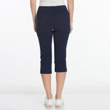 Navy blue capri pants worn by a person on a white background