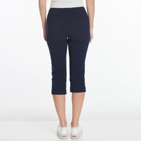 Navy blue capri pants worn by a person on a white background