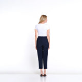 Woman wearing a white top and navy pants on a white background