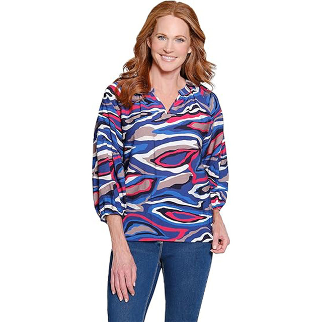 Woman wearing a colorful patterned top on a white background