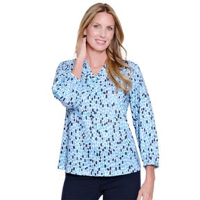 Woman wearing a blue patterned blouse on a white background