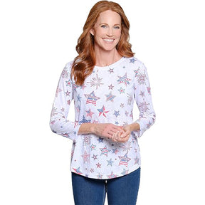 Woman wearing a white long-sleeve shirt with star and flag pattern on a white background