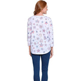 Woman wearing a white long-sleeve shirt with star pattern on a white background