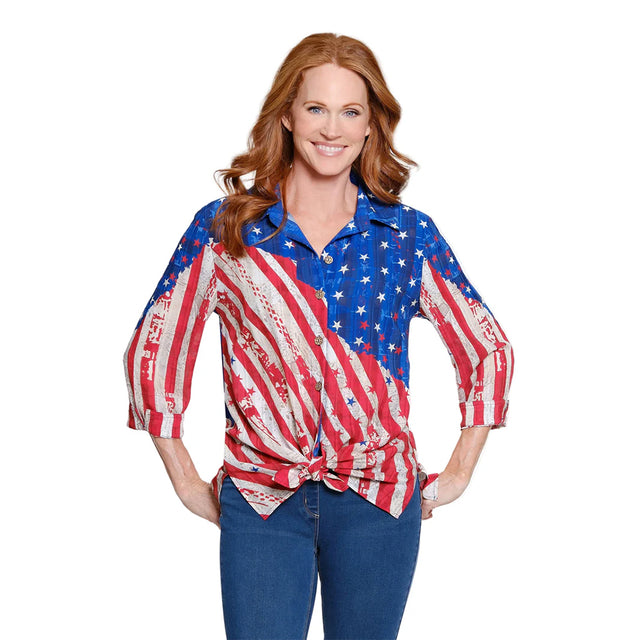 Woman wearing a colorful shirt with an American flag design on a white background