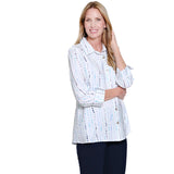 Woman wearing a white patterned blouse on a white background