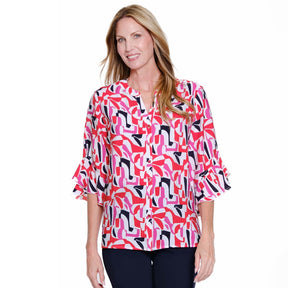 Woman wearing a colorful patterned blouse on a white background
